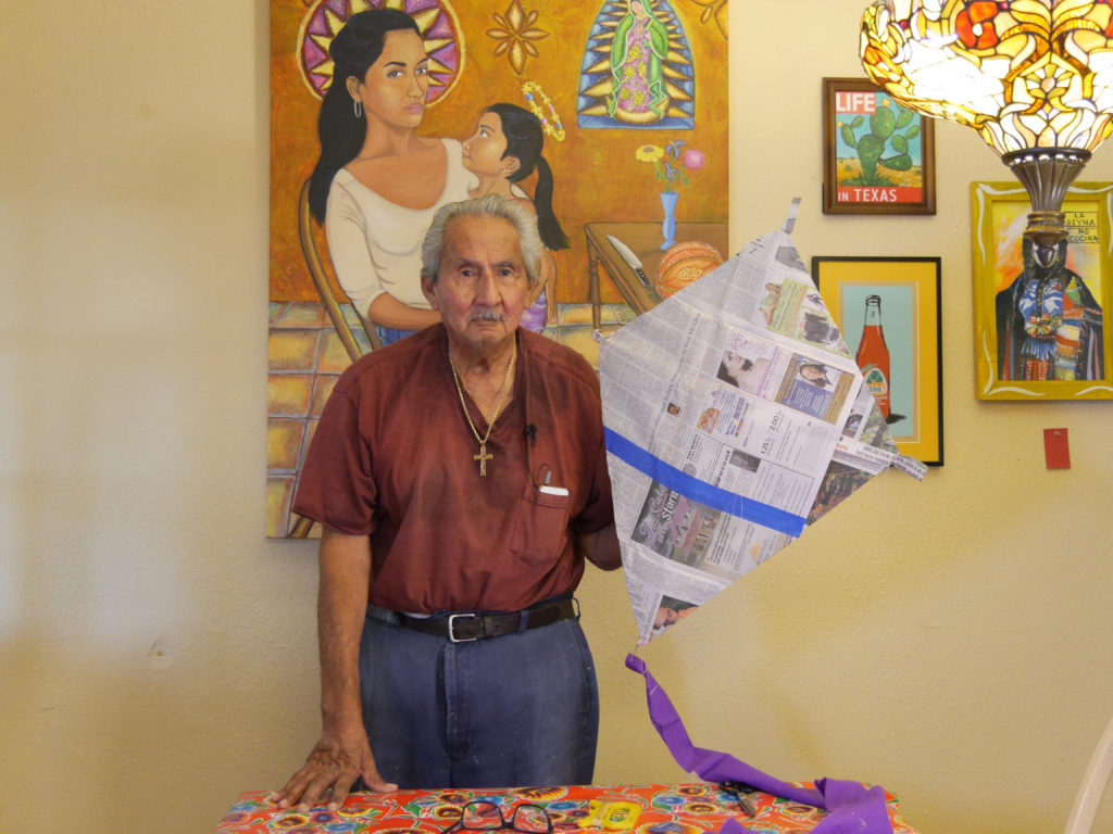 Kites Sin Fronteras, 2016, video still. Documentation of an intergenerational and cultural tradition of making kites from newspaper. IN this video a grandfather and granddaughter work to build a kite together. Project concept developed as part of Activating Vacancy Arts Incubator in collaboration with buildingcommunityWORKSHOP. Image courtesy of Christina Patiño Houle and Celeste De Luna.