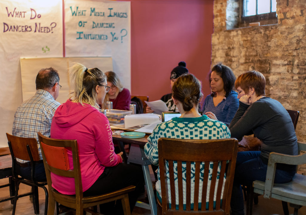 This first cohort of the Feminist Strip Club meets with University of Minnesota labor law specialist Stephen Befort to discuss employee vs. independent contractor status and worker misclassification. Photo by Boris Oicherman.
