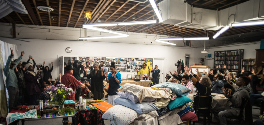 House/Full of Blackwomen Episode: "Black Womxn Dreaming," the blessing of the beds ceremony for a seven-day and night ritual of black women sleeping in a secret Oakland location. This ceremony invited the public to bring their pillows to be blessed, and to send the first wave of black women off to their ritual of rest, March 2017. Photo by Robbie Sweeny.