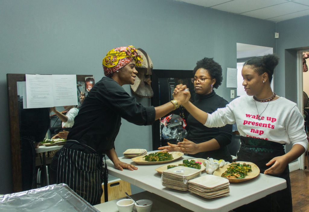 Chef Laquanda Dobson and volunteers Amaia and Nailah at the Zora Neale Hurston Dinner. Photo by Gabrielle Clark.
