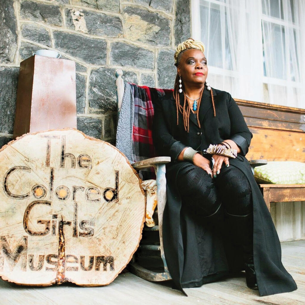 Executive Director and founder Vashti DuBois sits in front of The Colored Girls Museum.