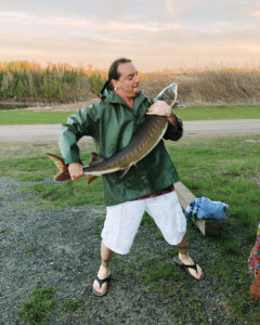 The author handles a male lake sturgeon in preparation of the spawn as part of the Ecovillage’s efforts to restore regional populations of the endangered species in surrounding watersheds.