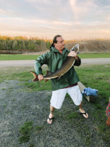 The author handles a male lake sturgeon in preparation of the spawn as part of the Ecovillage’s efforts to restore regional populations of the endangered species in surrounding watersheds.